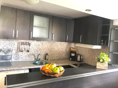 a kitchen with a bowl of fruit on a counter at Pavlovi Apartments in Samokov