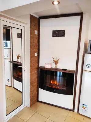 a living room with a fireplace in the wall at Pavlovi Apartments in Samokov