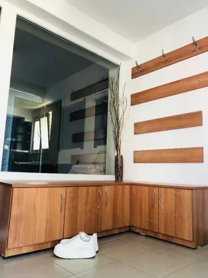a dressing room with a mirror and white shoes at Pavlovi Apartments in Samokov