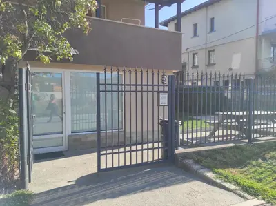 a gate in front of a building at Pavlovi Apartments in Samokov