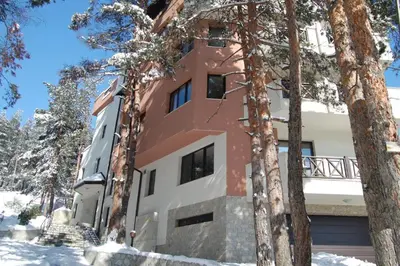 a building with trees in front of it at Bendida Apartments in Velingrad