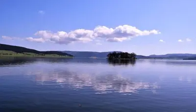 a large body of water with a island in the middle at Къща за гости ЕКО in Tsigov Chark
