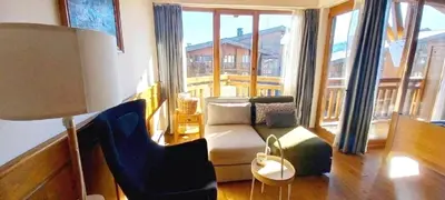 a living room with a couch and a large window at Airy Studio Pirin Golf Aparthotel SPA H2A92 in Razlog