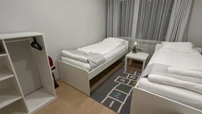 a small room with two beds and a table at 