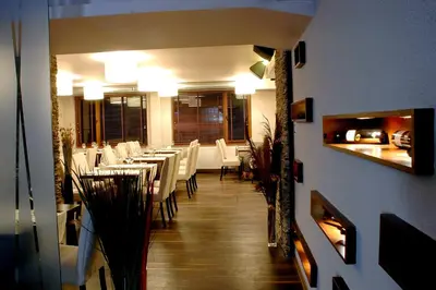 a dining room with white tables and white chairs at Апартамент DIMANI-Апартхотел Форест Нук Пампорово in Pamporovo