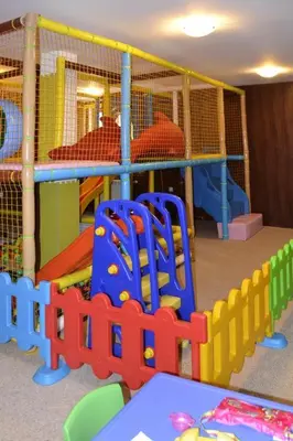 a childrens play room with a play area with toys at Апартамент DIMANI-Апартхотел Форест Нук Пампорово in Pamporovo