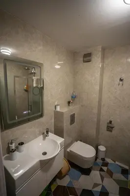 a bathroom with a white sink and a toilet at GUEST SUITE Narodno horo in Sofia