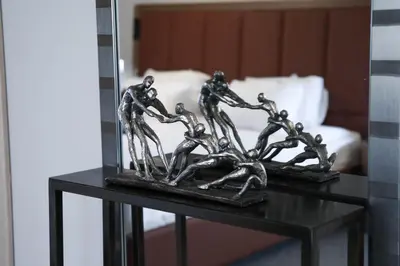 a metal sculpture of people on a table at Boutique Hotel Kanyon in Sofia