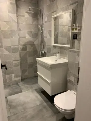 a bathroom with a toilet and a sink and a mirror at Golden Box Pamporovo in Pamporovo