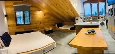 a bedroom with a bed and a table in a room at Golden Box Pamporovo in Pamporovo