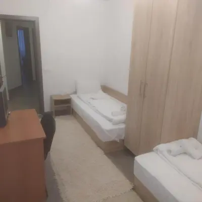 a small room with two beds and a desk at Fancy Big apartment in the heart of Sofia in Sofia