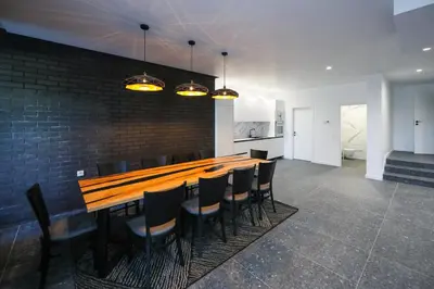 a dining room with a long wooden table and chairs at GRAFFIT Luxury houses in Ognyanovo