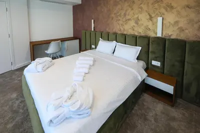 a bedroom with a large bed with towels on it at GRAFFIT Luxury houses in Ognyanovo