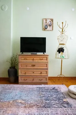 a television on a wooden dresser in a living room at Infinity Boutique Apartments in Bansko