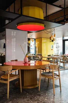 a dining room with a large wooden table and chairs at Hotel Kitchen59 in Sofia