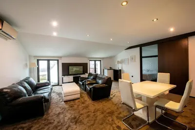 a living room with a couch and a table and chairs at Hotel Villa Ekaterina in Vakarel