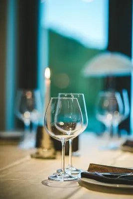 a wine glass sitting on top of a table at Hotel Villa Ekaterina in Vakarel