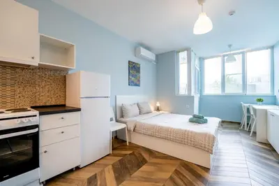 a small room with a bed and a kitchen at Cozy little apartment in Studentski grad in Sofia