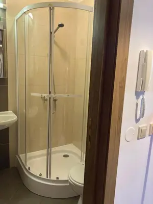 a bathroom with a shower with a toilet and a phone at Mirabell Studio Bansko - Amazing view & fireplace in Bansko