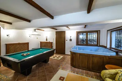 a pool table in a room with a tub at Villa Anna Luxury Lake Residence in Shtarkelovo Gnezdo