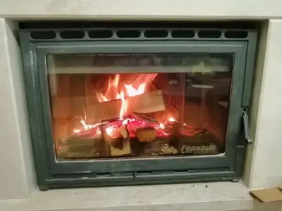 a fire in a fireplace with food in it at GRAND MONASTERYl Apartment ``Star Paradise`` in Pamporovo