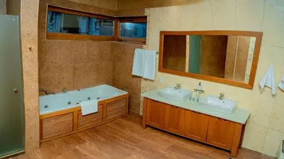 a bathroom with two sinks and a tub and a mirror at Luxury houses in Dobrinishte in Dobrinishte