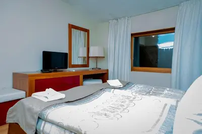 a hotel room with a bed and a television at Luxury houses in Dobrinishte in Dobrinishte