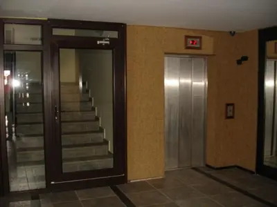 a hallway with stairs and a mirror in a building at Cozy Fortuna Apartments 46 in Bansko