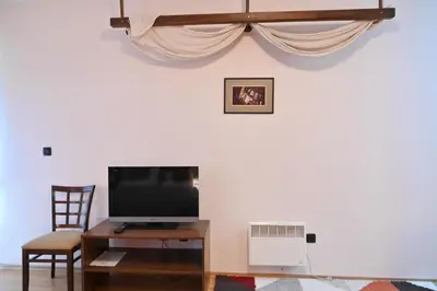 a living room with a tv and a table and a tv stand at Cozy Fortuna Apartments 46 in Bansko