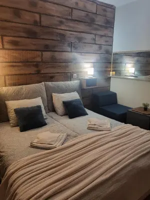 a bedroom with a large bed with two pillows on it at Boina House in Bansko