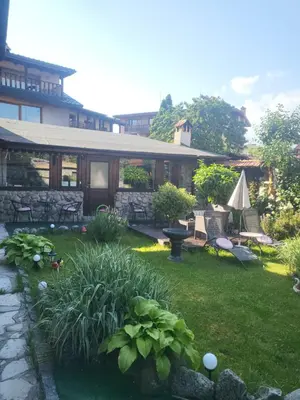 a yard with a house with a patio at Boina House in Bansko