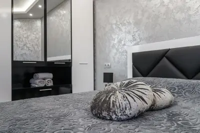 a large pillow sitting on a bed in a bedroom at City Apartments - a brand new luxury & comfy 2 in Asenovgrad