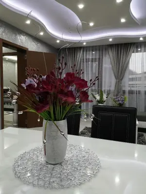 a vase filled with flowers sitting on a table at City Apartments - a brand new luxury & comfy 2 in Asenovgrad