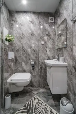 a bathroom with a sink and a toilet and a mirror at City Apartments - a brand new luxury & comfy 2 in Asenovgrad