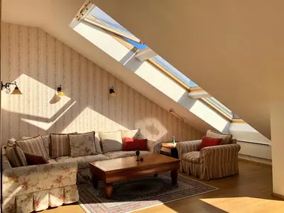 a living room with a couch and a table at LUXURY PENTHOUSE WITH A LAVISH SPA and 2 en-suite bedrooms in Bansko