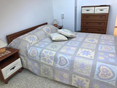 a bedroom with a bed and a dresser and a bed sidx sidx at LUXURY PENTHOUSE WITH A LAVISH SPA and 2 en-suite bedrooms in Bansko