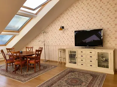 a dining room with a table and a tv at LUXURY PENTHOUSE WITH A LAVISH SPA and 2 en-suite bedrooms in Bansko