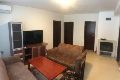 a living room with a couch and a television at Апартамент Пампорово Палас - Pamporovo Palace in Pamporovo