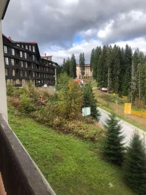 a view from a balcony of a building and trees at Апартамент Пампорово Палас - Pamporovo Palace in Pamporovo