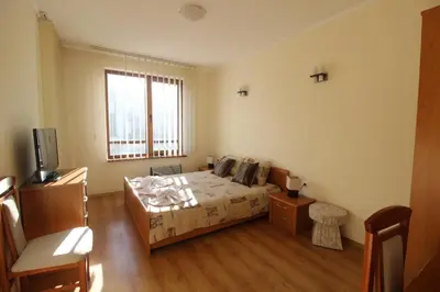 a bedroom with a bed and a television in it at 2 bedroom apartment near Gondola in Bansko