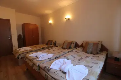 two beds in a room with towels on them at 2 bedroom apartment near Gondola in Bansko