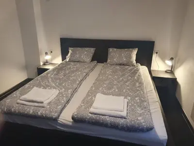 a bedroom with a bed with two pillows on it at The white apartment at the ski in Bansko