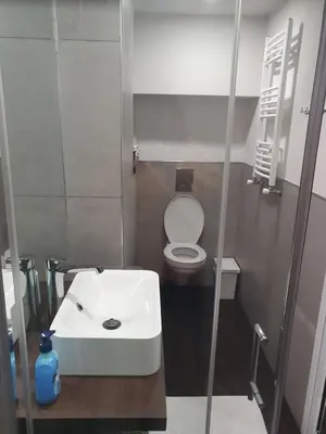 a small bathroom with a sink and a toilet at The white apartment at the ski in Bansko