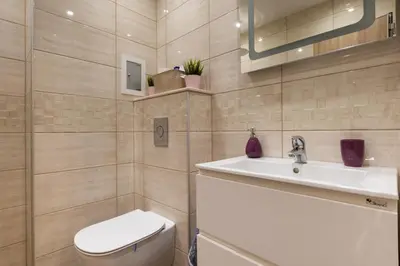a bathroom with a toilet and a sink at Apartment City View 2 in Sofia