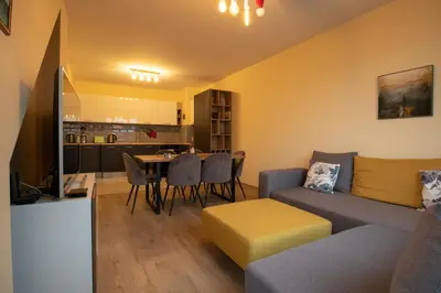 a living room with a couch and a table at Apartment City View 2 in Sofia