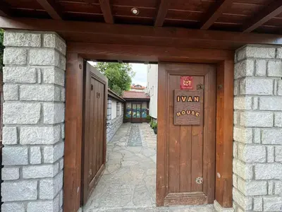 an entrance to a house with a wooden door at Guest House Ivan in Bansko