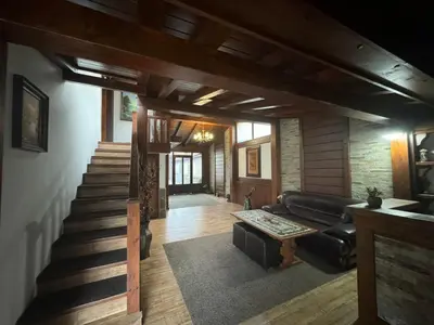 a living room with a couch and a stair case at Guest House Ivan in Bansko