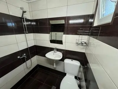 a bathroom with a toilet and a sink at Guest House Ivan in Bansko