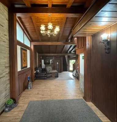 a hallway of a home with wooden ceilings and a chandelier at Guest House Ivan in Bansko