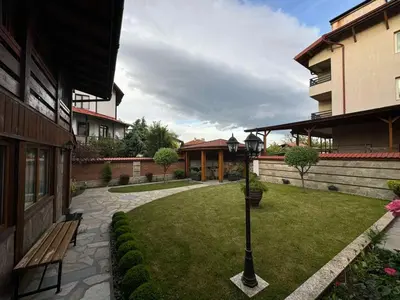 a courtyard with a bench and a street light at Guest House Ivan in Bansko